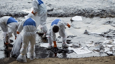 People cleaning up at the beach